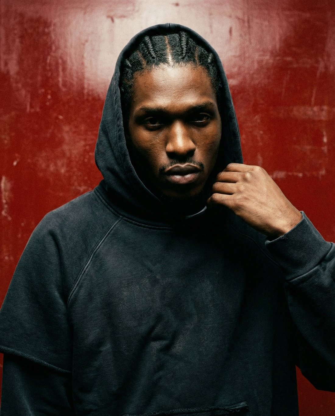 Champion Limited Edition — hoodie up, hand on the collar