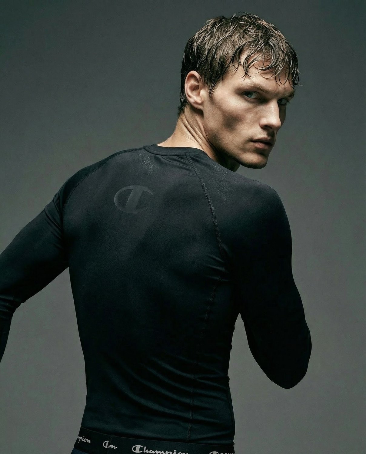Champion — black compression top, looking back