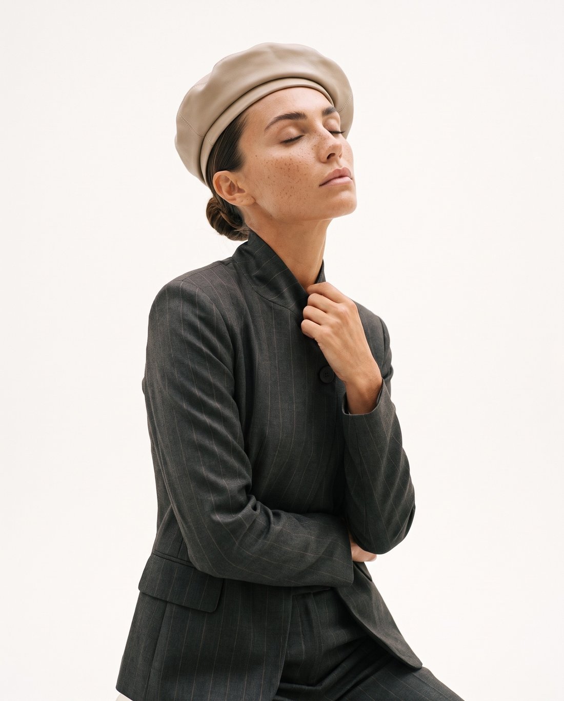 Republica — grey pinstripe jacket and leather beret, eyes closed