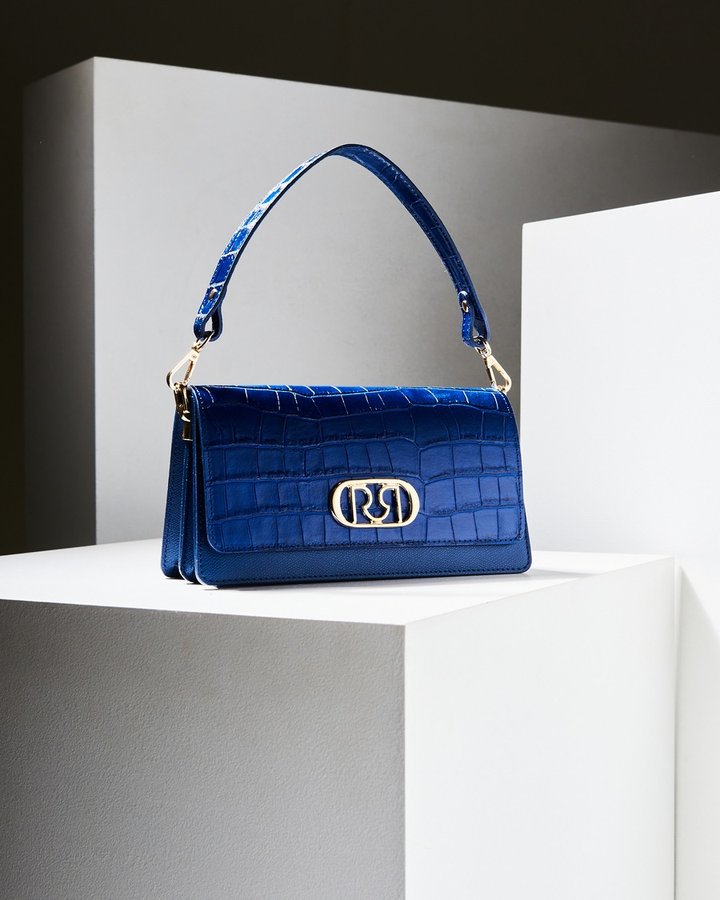 Rinascimento — blue croc bag on a plinth